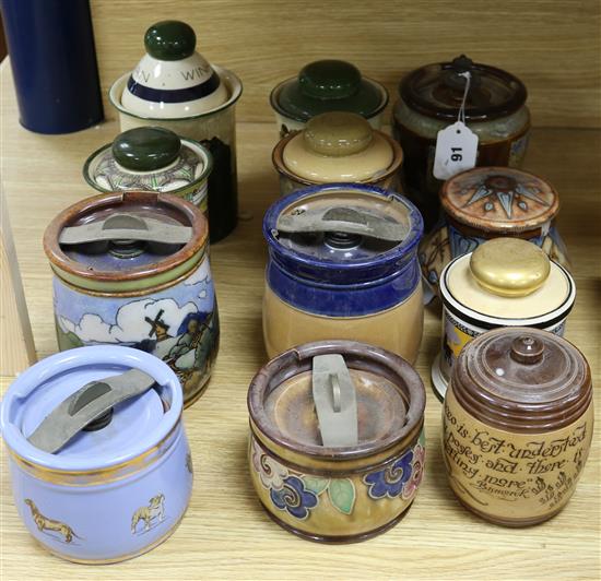Twelve Doulton tobacco jars and covers, various designs including an example by Florrie Jones